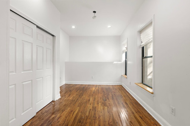 unfurnished bedroom featuring dark hardwood / wood-style floors and a closet