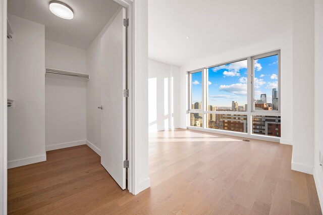 75 Park Ln S Unit 1912, Jersey City, NJ 07310 - hall with light wood-type flooring, baseboards, and a view of city