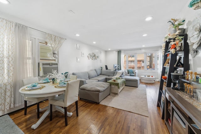 living room featuring cooling unit and dark hardwood / wood-style flooring