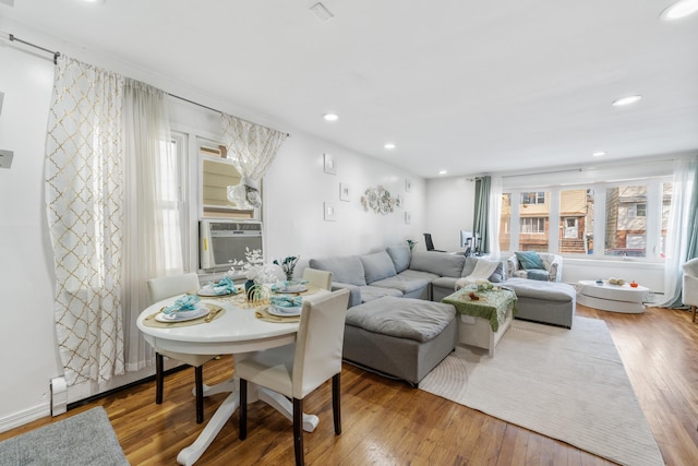 living room with cooling unit and hardwood / wood-style floors