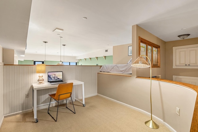 office featuring visible vents, light colored carpet, baseboards, and a wainscoted wall