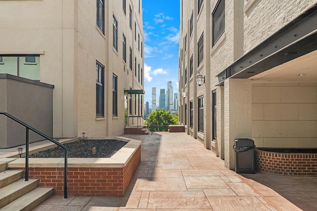 surrounding community with a view of city and a patio