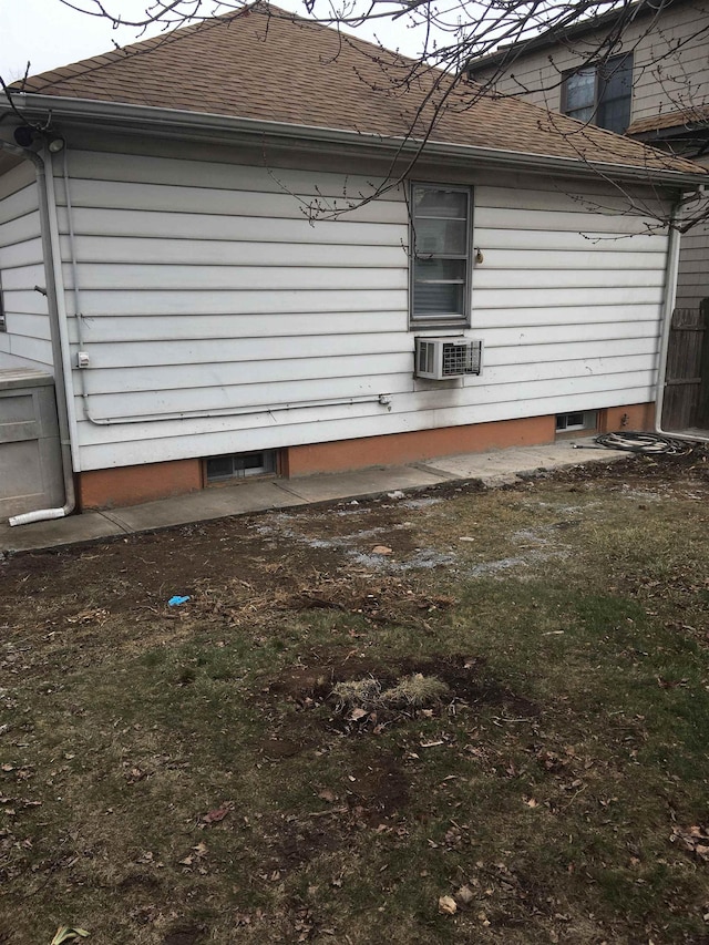 view of side of property with roof with shingles