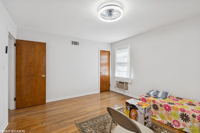 corridor featuring dark wood-style flooring, baseboards, and a wall mounted AC