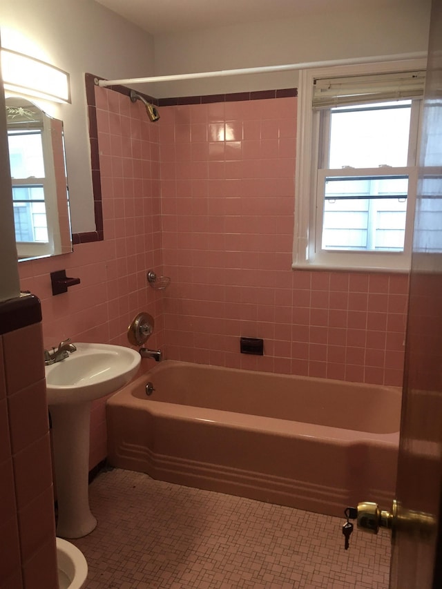 bathroom featuring tile patterned flooring, shower / tub combination, and tile walls