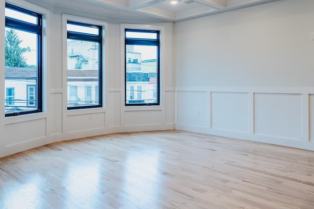 141 Sherman Ave Unit 2, Jersey City, NJ 07307 - unfurnished room featuring a decorative wall, beam ceiling, light wood-style flooring, plenty of natural light, and coffered ceiling