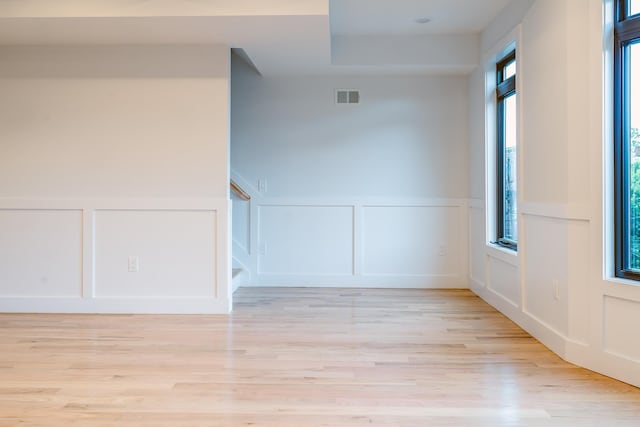 141 Sherman Ave Unit 2, Jersey City, NJ 07307 - unfurnished room with a decorative wall, light wood finished floors, a wainscoted wall, and stairway