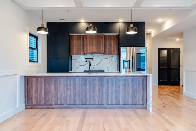 141 Sherman Ave Unit 2, Jersey City, NJ 07307 - kitchen with stainless steel refrigerator with ice dispenser, modern cabinets, light countertops, decorative backsplash, and light wood finished floors