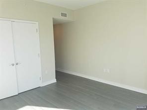 1200 Avenue At Port Imperial Unit 519, Weehawken, NJ 07086 - unfurnished bedroom featuring wood finished floors and a closet