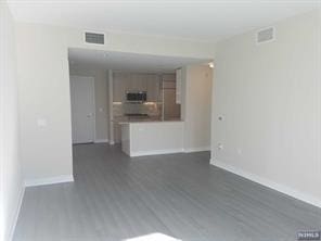 1200 Avenue At Port Imperial Unit 519, Weehawken, NJ 07086 - unfurnished living room featuring dark wood-style floors