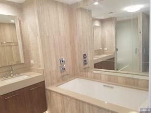 1200 Avenue At Port Imperial Unit 519, Weehawken, NJ 07086 - bathroom featuring tiled bath, vanity, and a shower