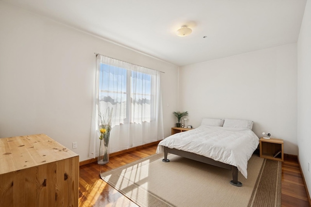 bedroom featuring baseboards and wood finished floors