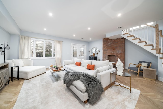 living room featuring baseboards, stairway, french doors, a brick fireplace, and recessed lighting