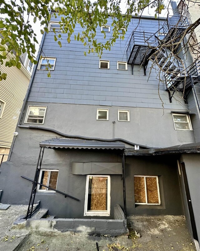 552 38th St Unit 3, Union City, NJ 07087 - rear view of house featuring stucco siding
