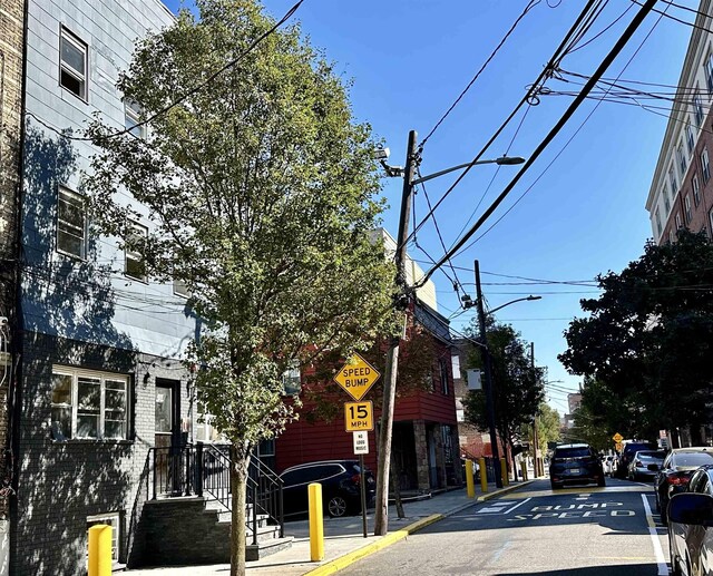 552 38th St Unit 3, Union City, NJ 07087 - view of asphalt road with traffic signs, street lighting, sidewalks, and curbs