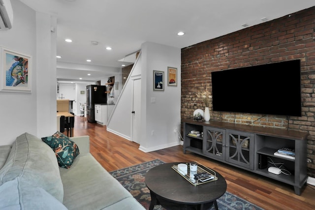 123 Willow Ter, Hoboken, NJ 07030 - living room with wood finished floors, stairway, recessed lighting, an AC wall unit, and brick wall
