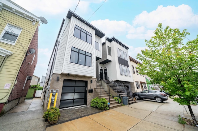 109 Poplar St Unit 1, Jersey City, NJ 07307 - view of front of house with a garage, brick siding, and driveway