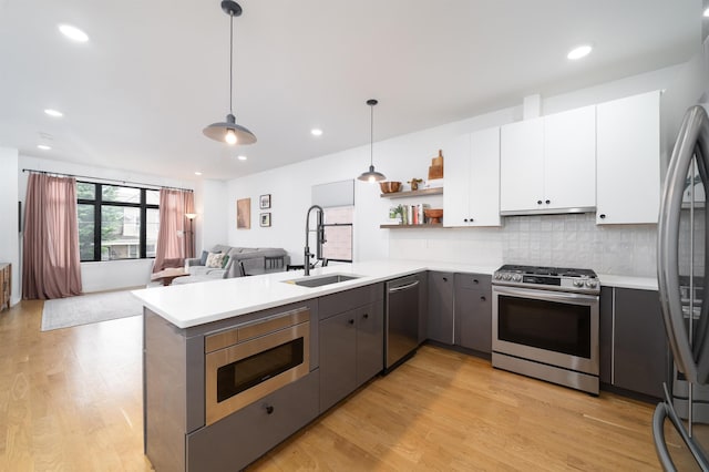 109 Poplar St Unit 1, Jersey City, NJ 07307 - kitchen featuring stainless steel appliances, a sink, light countertops, white cabinetry, and recessed lighting
