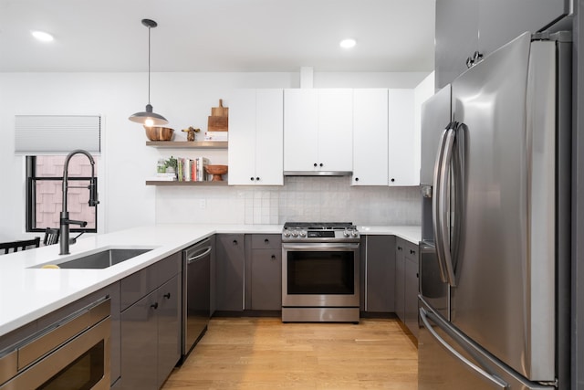 109 Poplar St Unit 1, Jersey City, NJ 07307 - kitchen with appliances with stainless steel finishes, a sink, open shelves, light countertops, and recessed lighting