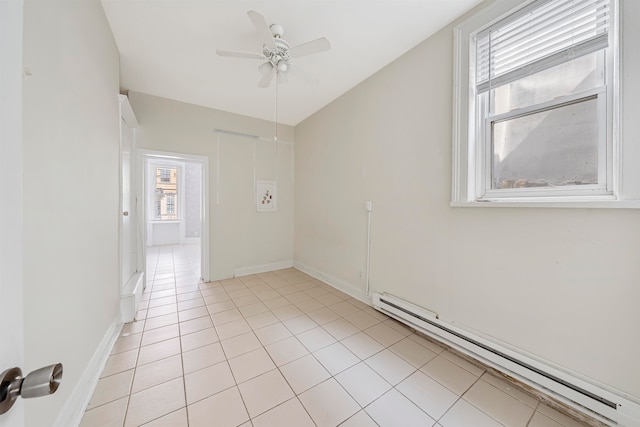 tiled empty room featuring a baseboard radiator and ceiling fan