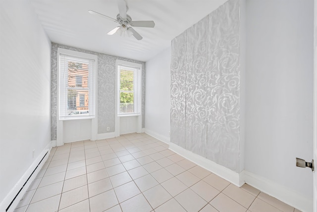 tiled spare room with a baseboard radiator and ceiling fan