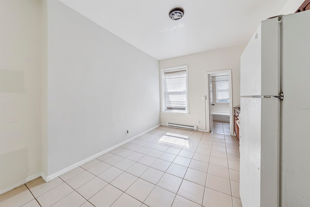 tiled empty room with baseboard heating