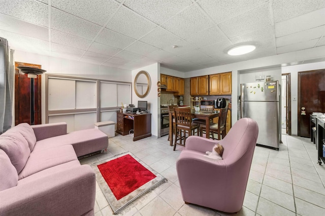 tiled living room with a drop ceiling