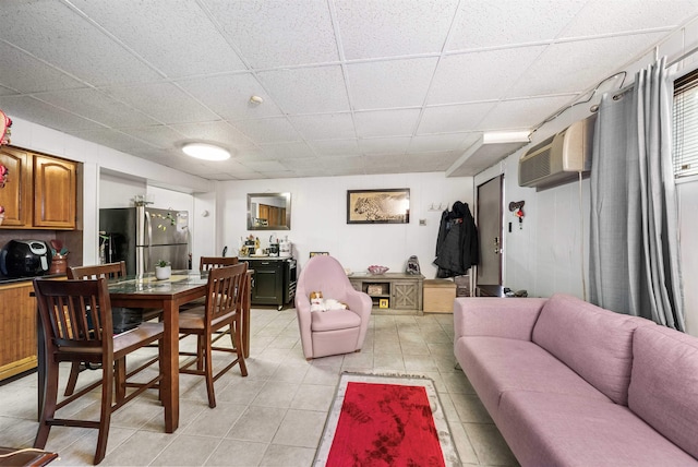 interior space with a drop ceiling and a wall mounted air conditioner