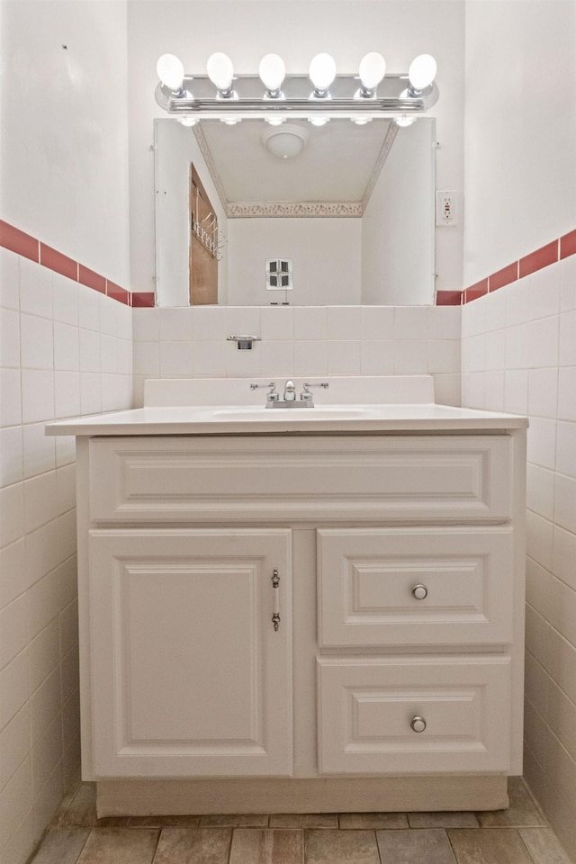 22 W 34th St Unit G, Bayonne, NJ 07002 - bathroom featuring tile walls, vanity, tile patterned flooring, and a wainscoted wall