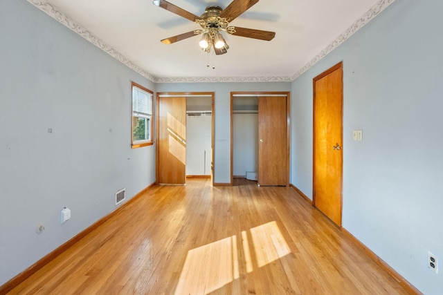 22 W 34th St Unit G, Bayonne, NJ 07002 - unfurnished bedroom with two closets, light wood-style flooring, baseboards, and a ceiling fan