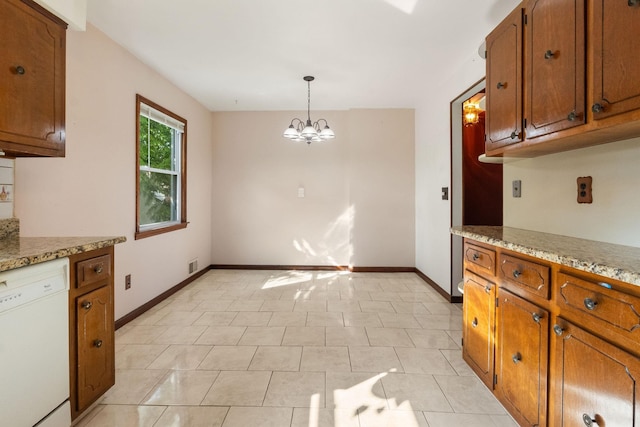 22 W 34th St Unit G, Bayonne, NJ 07002 - kitchen with white dishwasher, brown cabinetry, baseboards, and a chandelier