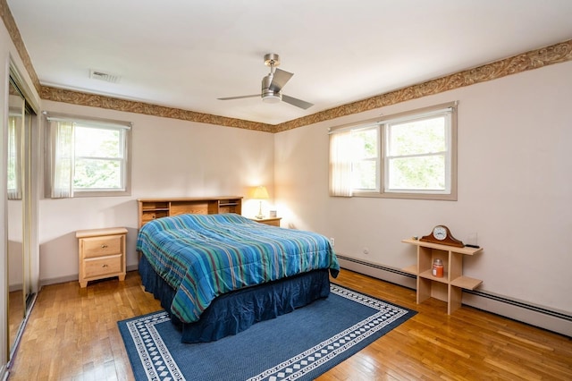 151 Mount Pleasant Ave, Dover Town, NJ 07801 - bedroom featuring multiple windows, a baseboard radiator, wood-type flooring, and ceiling fan