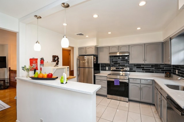 151 Mount Pleasant Ave, Dover Town, NJ 07801 - kitchen featuring stainless steel appliances, gray cabinetry, under cabinet range hood, a peninsula, and decorative backsplash
