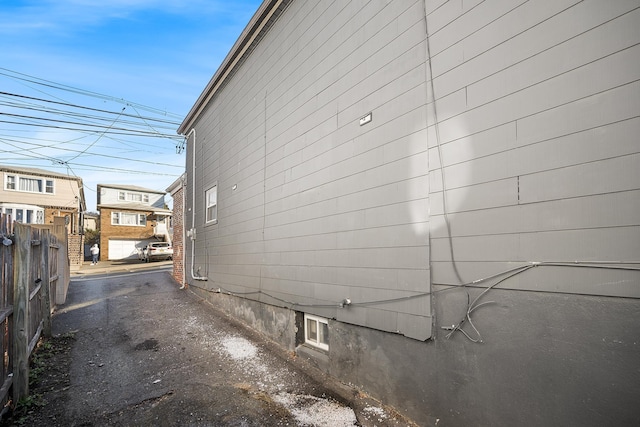 view of side of property featuring fence