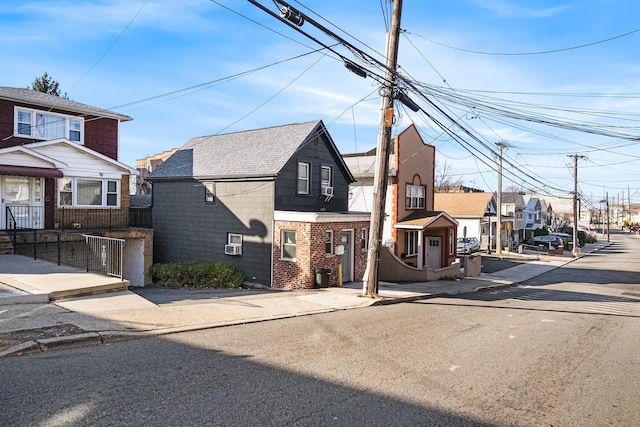 view of front of property with a residential view and brick siding