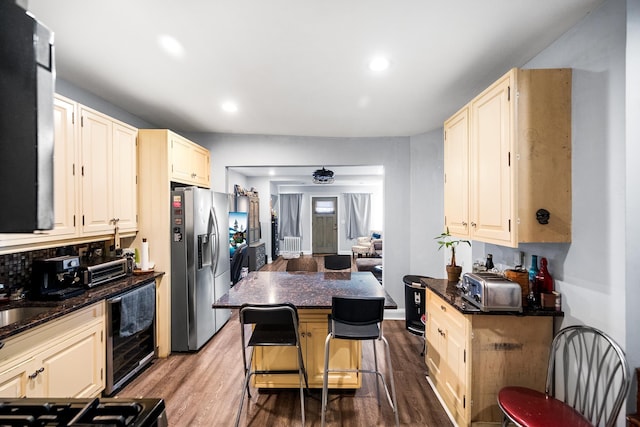 kitchen featuring ceiling fan, wine cooler, wood finished floors, stainless steel refrigerator with ice dispenser, and recessed lighting