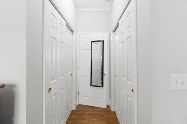 hallway with hardwood / wood-style flooring and crown molding