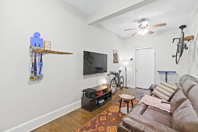 living room with ceiling fan, beam ceiling, and hardwood / wood-style floors