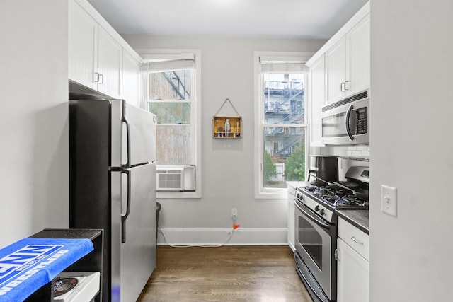 kitchen featuring white cabinets, cooling unit, appliances with stainless steel finishes, and dark hardwood / wood-style flooring