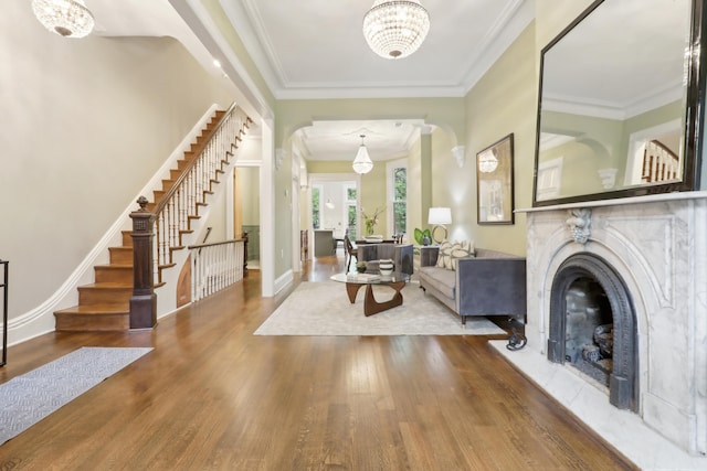 254 4th St, Jersey City, NJ 07302 - entryway with wood finished floors, stairs, a fireplace, crown molding, and a chandelier
