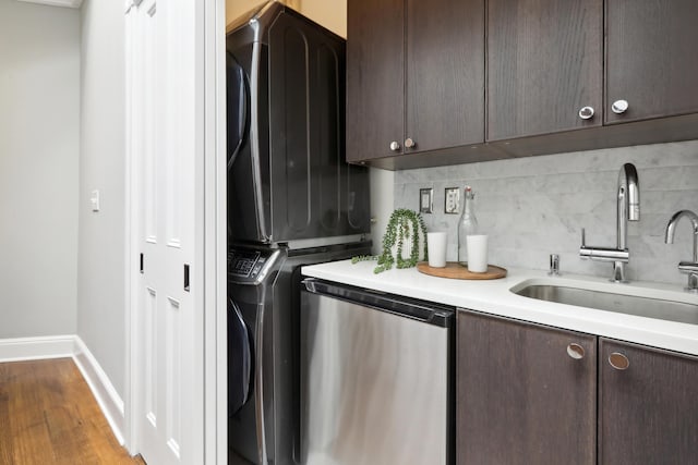254 4th St, Jersey City, NJ 07302 - laundry room with estacked washer and dryer, baseboards, and wood finished floors