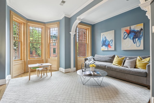 254 4th St, Jersey City, NJ 07302 - living area featuring baseboards, crown molding, arched walkways, and wood finished floors