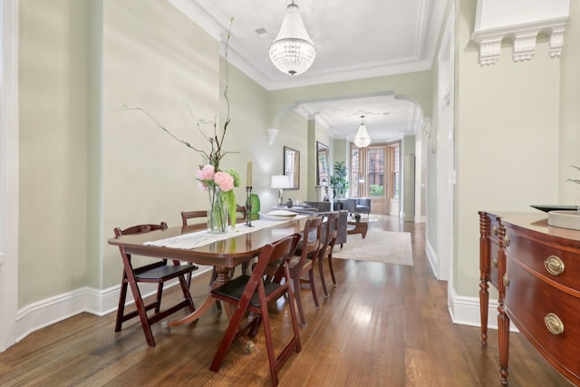 254 4th St, Jersey City, NJ 07302 - dining space with a chandelier, arched walkways, crown molding, wood finished floors, and baseboards