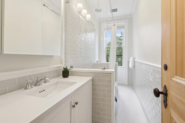 254 4th St, Jersey City, NJ 07302 - bathroom featuring tile walls, ornamental molding, wainscoting, vanity, and tile patterned floors