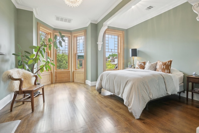 254 4th St, Jersey City, NJ 07302 - bedroom with wood finished floors, baseboards, ornamental molding, and a chandelier