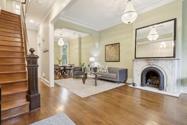 254 4th St, Jersey City, NJ 07302 - living room with ornamental molding, a chandelier, stairs, wood finished floors, and baseboards