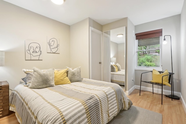 254 4th St, Jersey City, NJ 07302 - bedroom with light wood-type flooring and baseboards