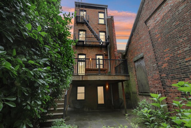 254 4th St, Jersey City, NJ 07302 - back of house with brick siding and a balcony