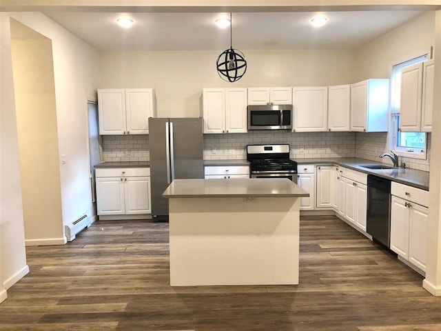 549 Pavonia Ave Unit 1 & 2, Jersey City, NJ 07306 - kitchen featuring appliances with stainless steel finishes, a baseboard heating unit, a sink, white cabinetry, and a kitchen island