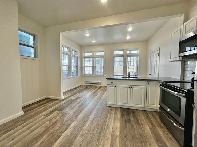 549 Pavonia Ave Unit 1 & 2, Jersey City, NJ 07306 - kitchen with stainless steel appliances, a sink, a baseboard radiator, dark wood finished floors, and healthy amount of natural light